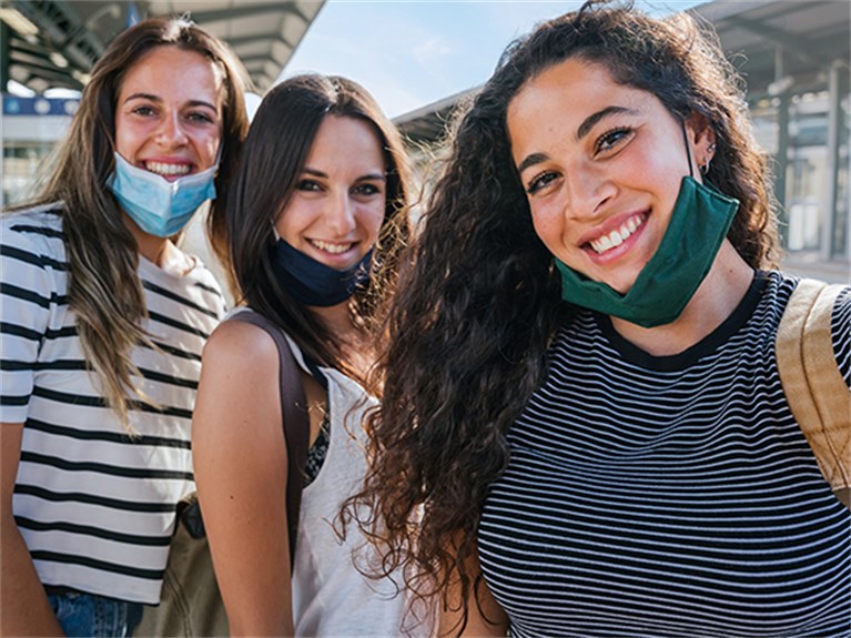 Three friends taking a selfie on a train platform